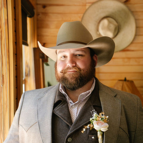 Groom wearing ranch formal attire before wedding in rustic Oklahoma chapel