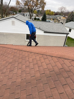 employee blowing out gutter system