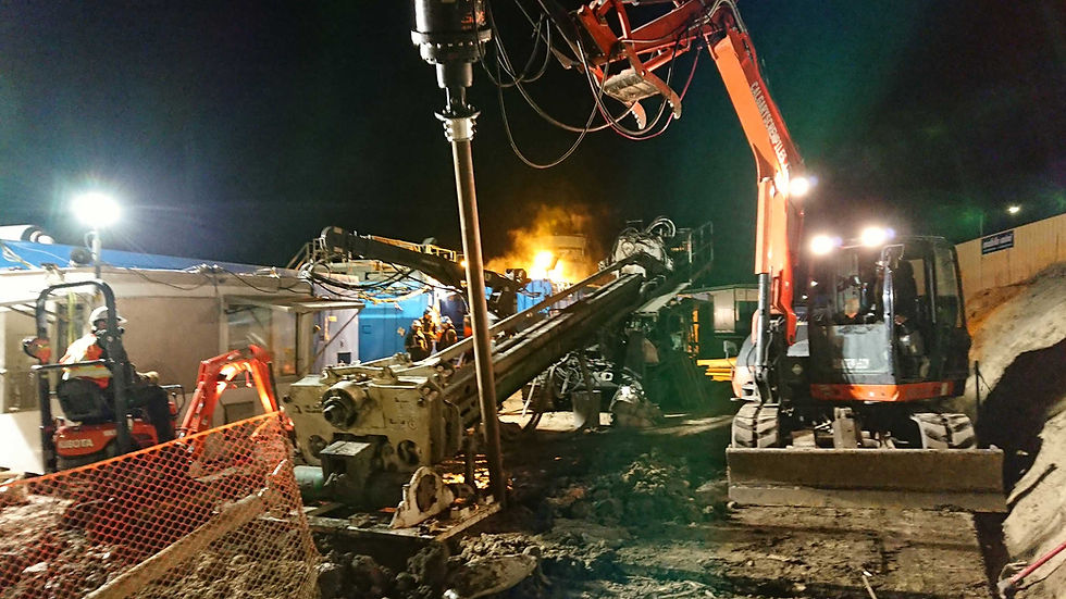 Screw piles being quickly installed at the site of a stalled drilling rig.