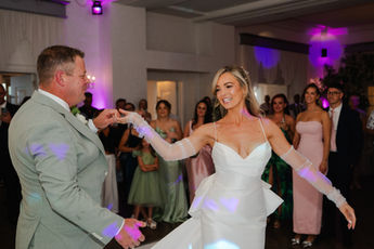Bride and groom sharing their first dance surrounded by guests at Hythe Imperial Hotel, Kent.
