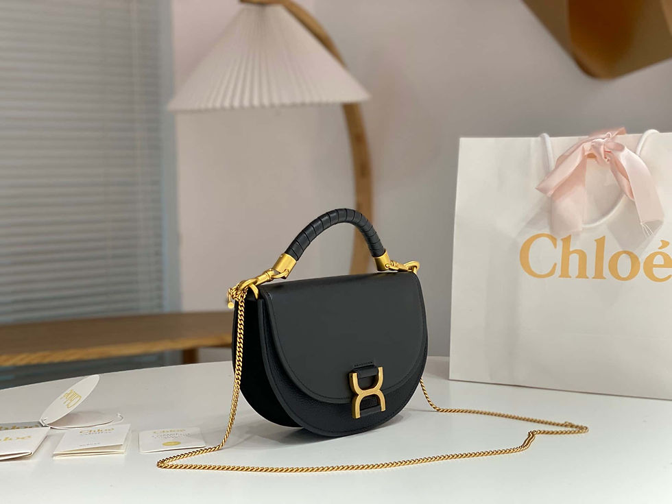 The Chloé Marcie 23 Crescent Bag Black blends nappa lambskin, grained calfskin, and suede with signature hardware reinterpret