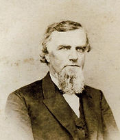 Benjamin Edwards in middle age He is wearing a suit and has a full goatee nearly reaching to his chest. He is unsmiling and his hair curls past his ears and is combed to the side.