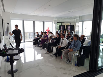 Doctor giving a presentation to a group of people at a conference. MD Codes