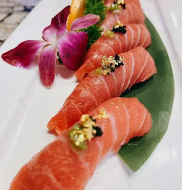 Delicious sushi, kamiya sushi, fresh salmon and garnishes, beautifully plated, ready to eat.