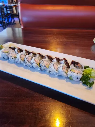 Sushi roll on plate at Kamiya Sushi restaurant, fresh ingredients.