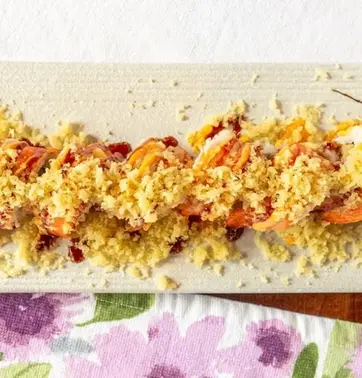 Tempura shrimp sushi dish with topping on a white plate kamiya sushi restaurant.