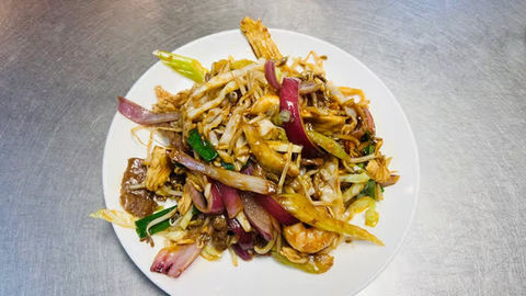 Plate of noodles with vegetables and meat; a delicious prepared meal