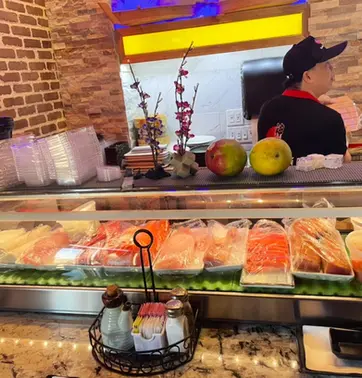 Sushi chef and fresh fish display at Kamiya Sushi restaurant