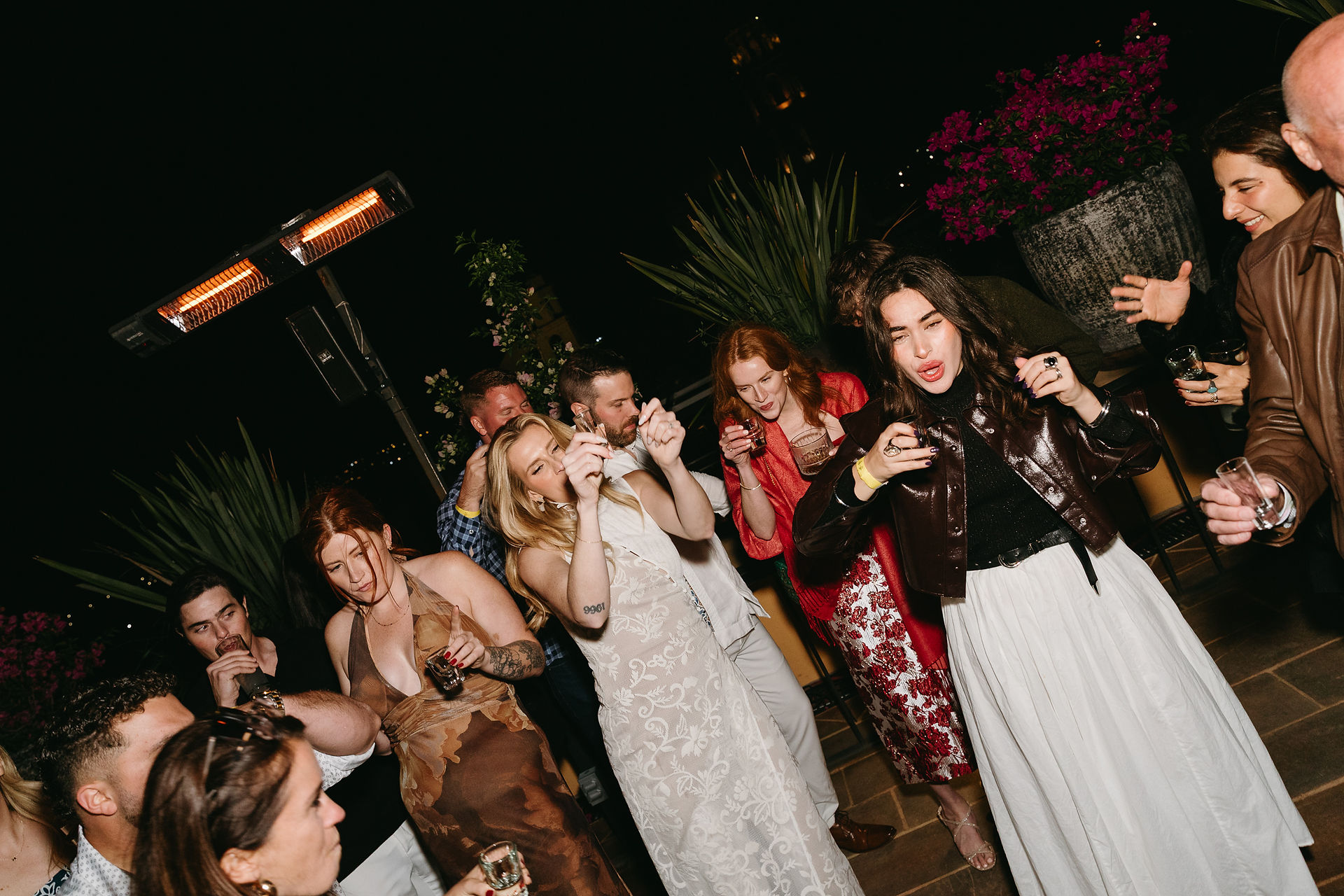 Rooftop welcome party in San Miguel de Allende with guests celebrating at sunset