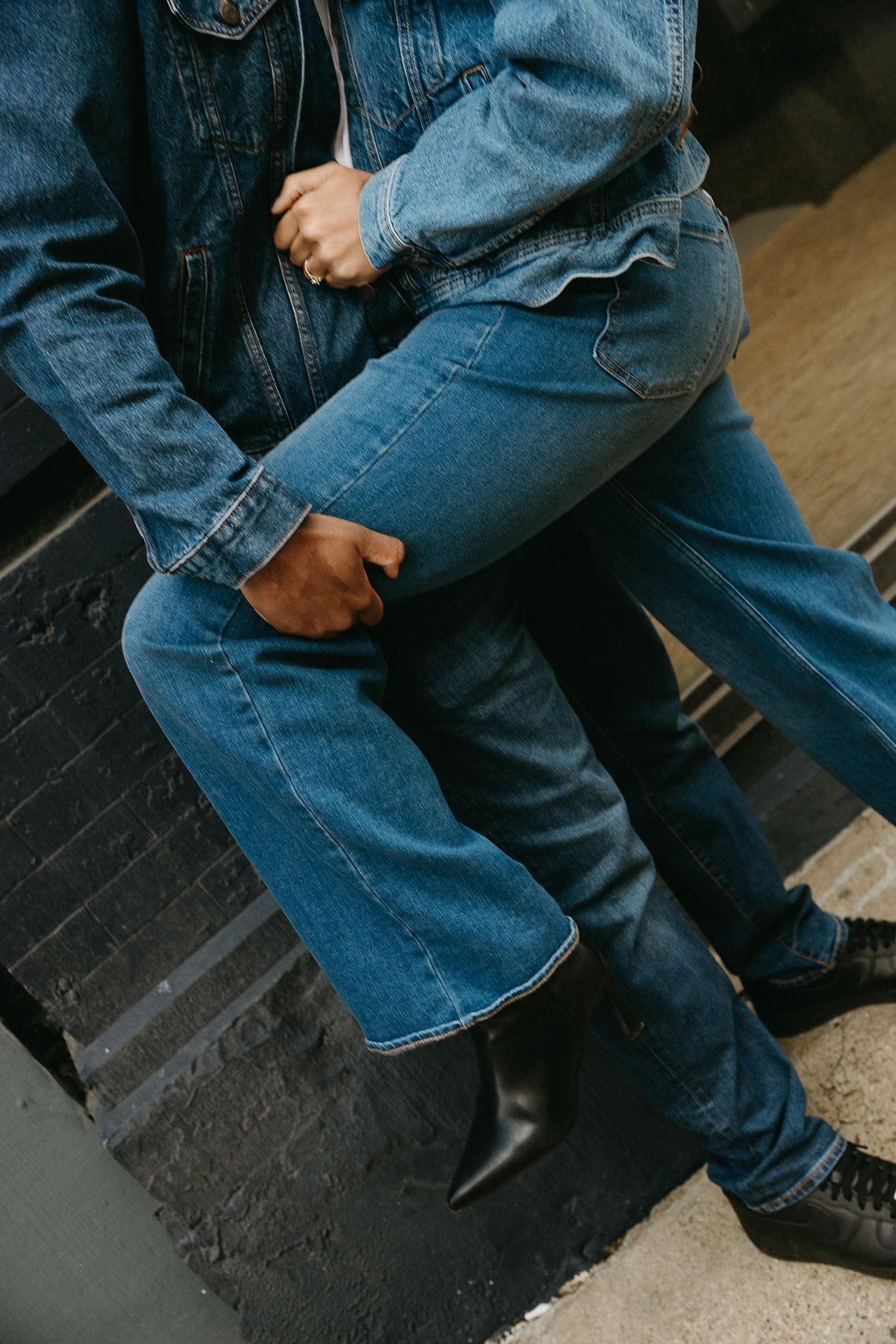 Closeup of denim outfits during engagement photos