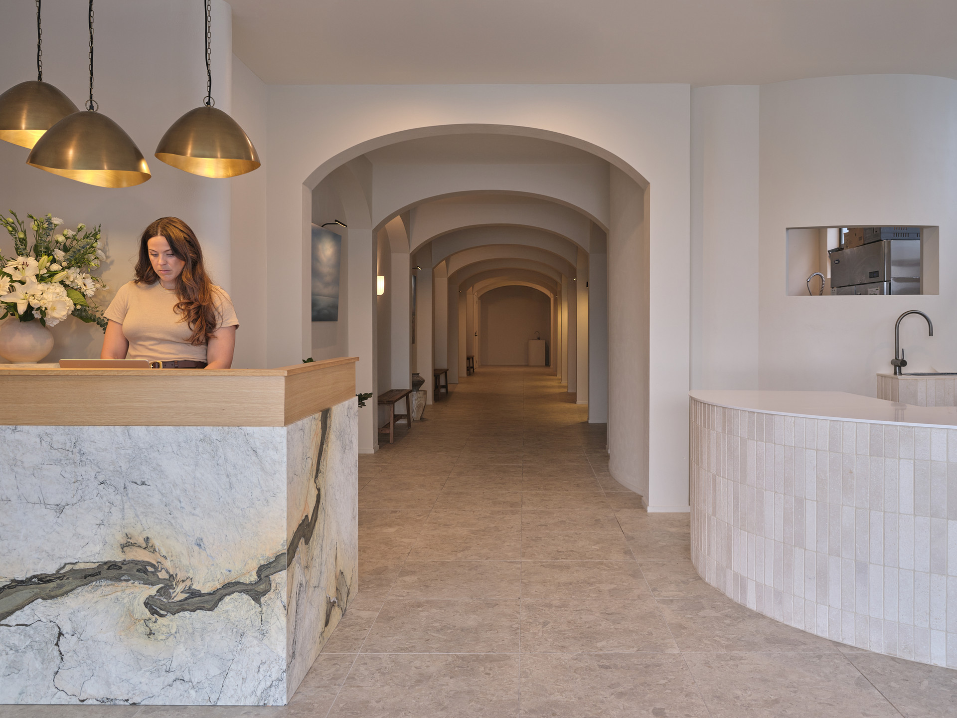 The host at the marble reception desk of Twenty Two Mokoia