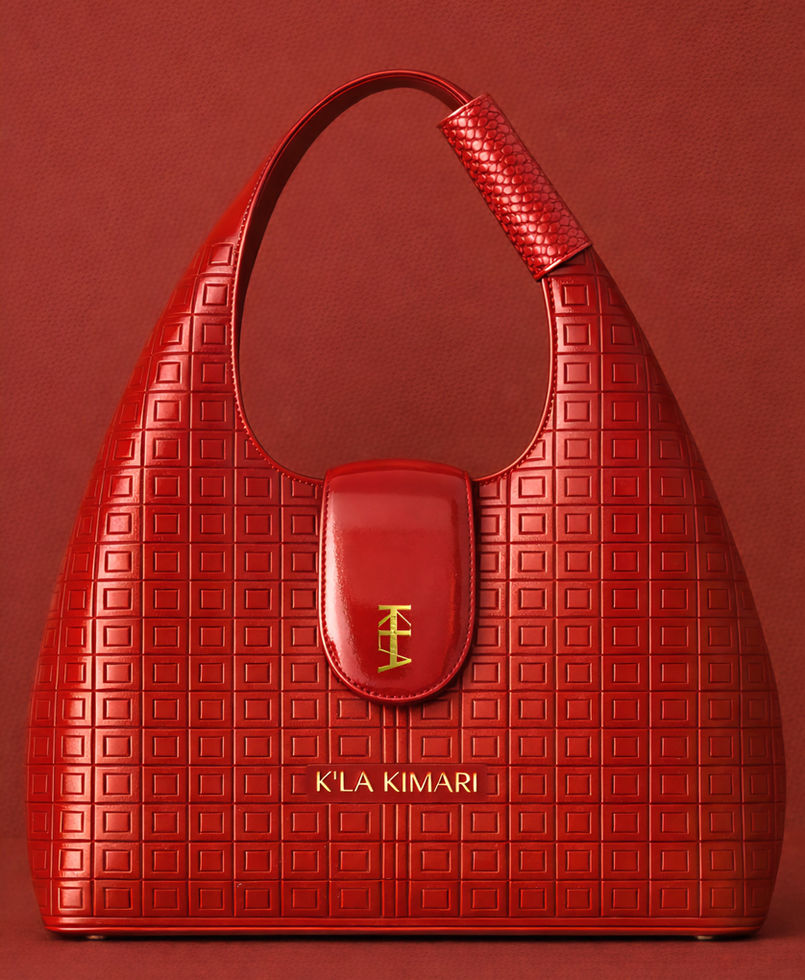 Red 18" high egg shaped calf leather handbag, oval flap closure has gold logo accent, leather wrap over the handle-close