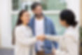Couple of happy home buyers and Indian real estate agent closing house buying deal with ha