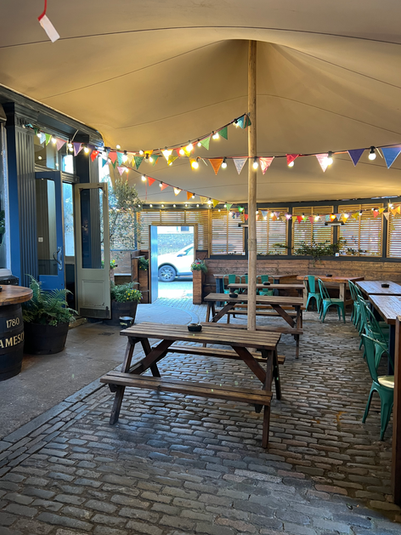Beer garden with tables and chairs at the Askew, independent pub in Shepherd’s Bush, West London