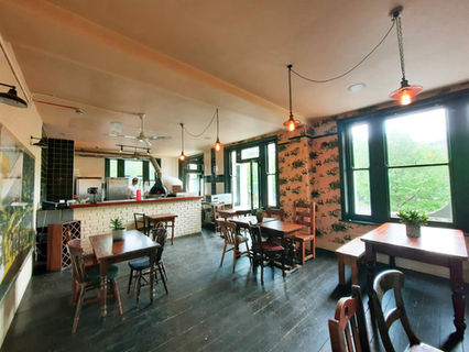 Second floor with tables, chairs and kitchen at the Three Stags, independent Lambeth pub in London.