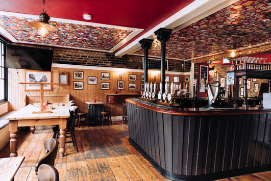 Bar, tables and chairs at the Bricklayer’s Arms, Putney independent pub in South West London.