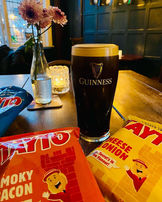 Guinness and crisps at the Herne, independent pub in South London.