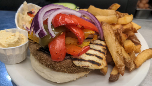 Burger with peppers and onion at Lord Nelson, an independent Southwark pub in London.
