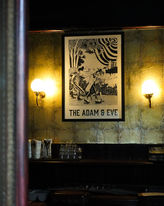 Poster and lamps on wall at the Adam and Eve, a Homerton independent pub in Hackney, East London