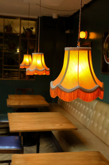 Hanging lamps, tables and bench at the Montpelier, independent pub in Peckham, South East London