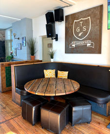Table, bench and stools at the Garden Shed, a Wimbledon independent pub with amazing beer garden.