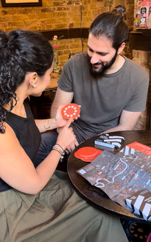 Couple looking at the CityStack pub voucher with a map of independent pubs