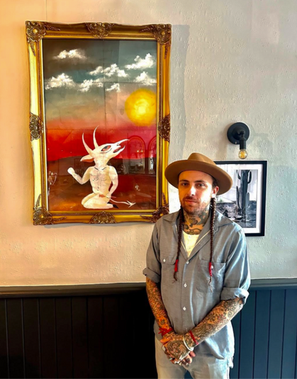 Artist and painting at the Hawke, independent Victoria park pub in East London.