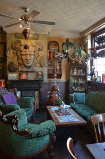 Sofa, table, memorabilia at the Prince of Greenwich, independent Greenwich pub in London.