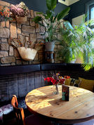 Table, plants and bench at the Captain Cook, Fulham independent pub in West London