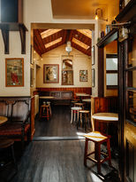 Back of the pub with stools, tables at the Pocket, independent pub in Islington, North London