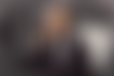 Businessman in suit on phone, smiling. Background shows silhouettes shaking hands, phone keypad, clock, "Sales Call Script," and arrows.