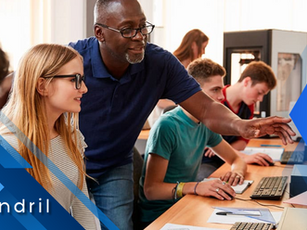 Instructor assists students on computers in a classroom. Natural light from windows. Blue geometric design with "tendril" text. Emphasis on learning.