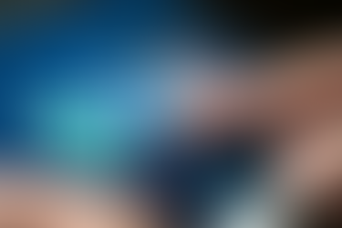 Finger taps a green smiling face on a touchscreen. Blue background with emoticons and "tendril" logo visible. Mood: Positive interaction.