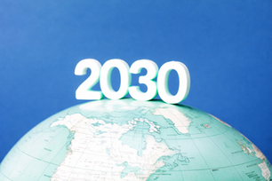 Globe with "2030" on top against a blue background, emphasizing future global themes. Calm and optimistic mood.