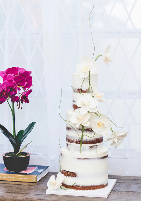 Three tier semi-naked wedding cake featuring sugar orchids