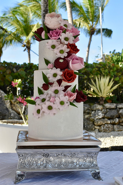 All white three tier wedding cake- designed with lace stencilling and cascading gumpaste flowers