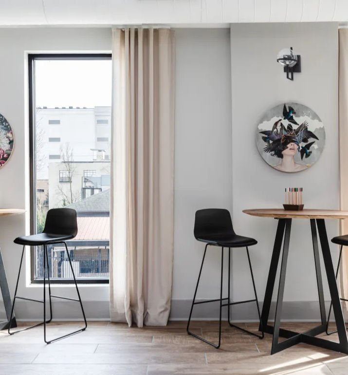 Modern commercial interior featuring bar-height tables, collaborative seating, and contemporary finish