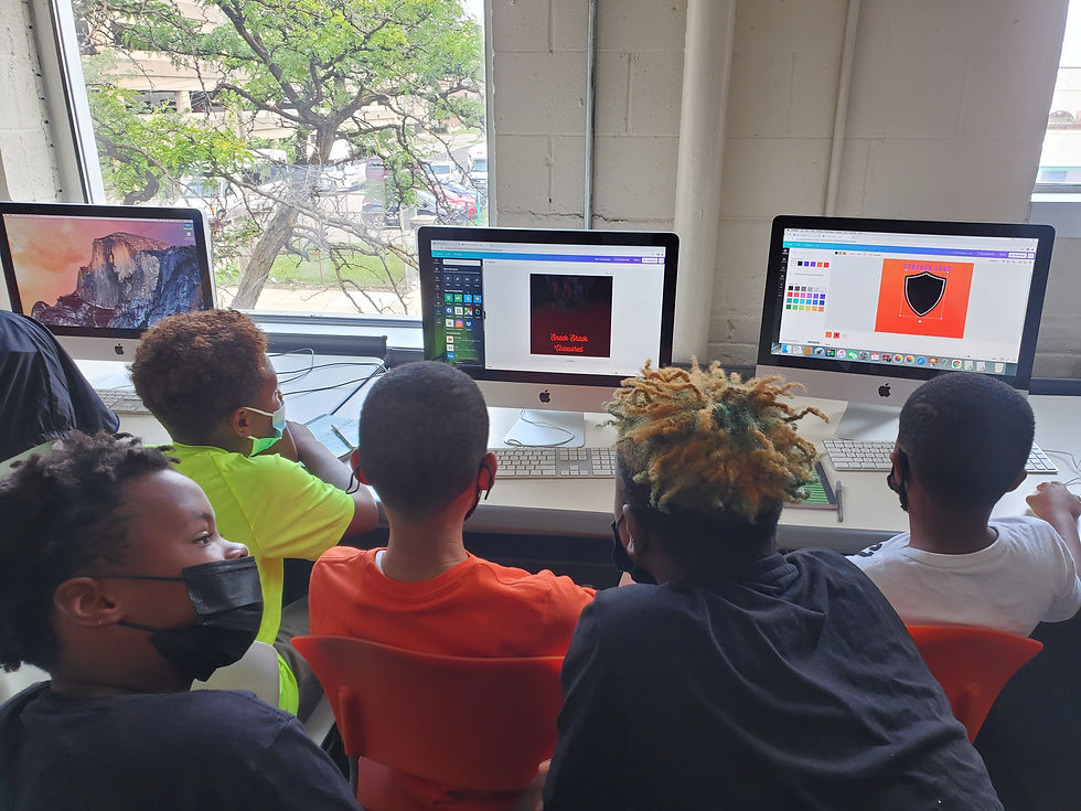 Youth at Franklin Wright Settlement's Youthville facility design logos and marketing materials during a BizKid camp experience.