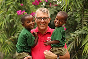 Founder Daniel Preuss at Streetkids Internationals Montessori Kindergarten with two children