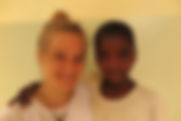 Louisa with orphan child at Tumaini Montessori Kindergarten