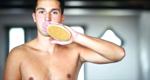 Man receiving Garshana-inspired dry brushing during a lymphatic massage session