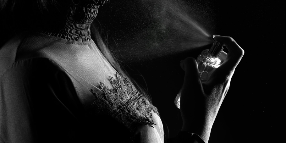 woman sprays perfume