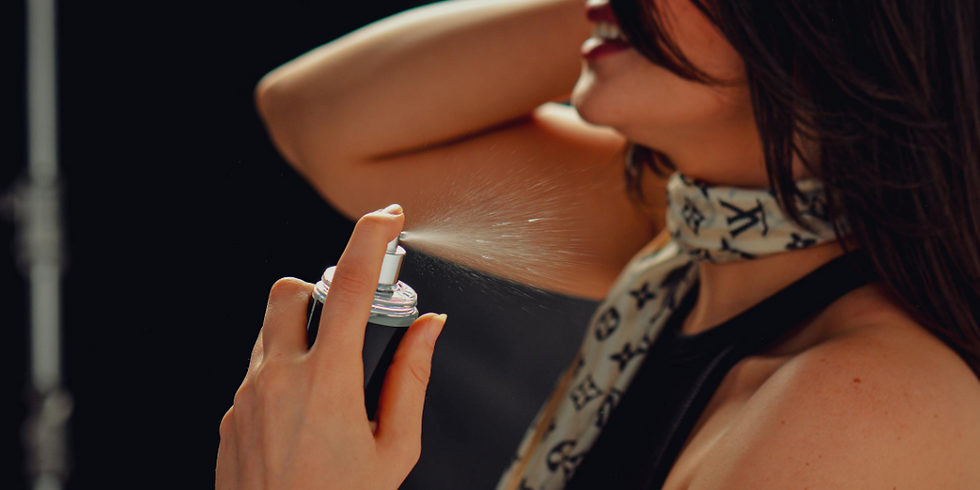 Woman spraying perfume on her neck