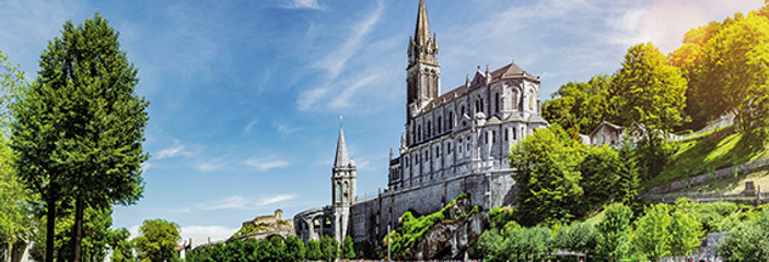 Panoramic View of Basilica Notre Dame in Lourdes France 1453346174 -® shutterstock - by-st