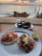 Fish tacos and hot sauces on the beach in Mexico