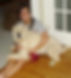 Picture of author as a teenager, cradling a large dog on her lap
