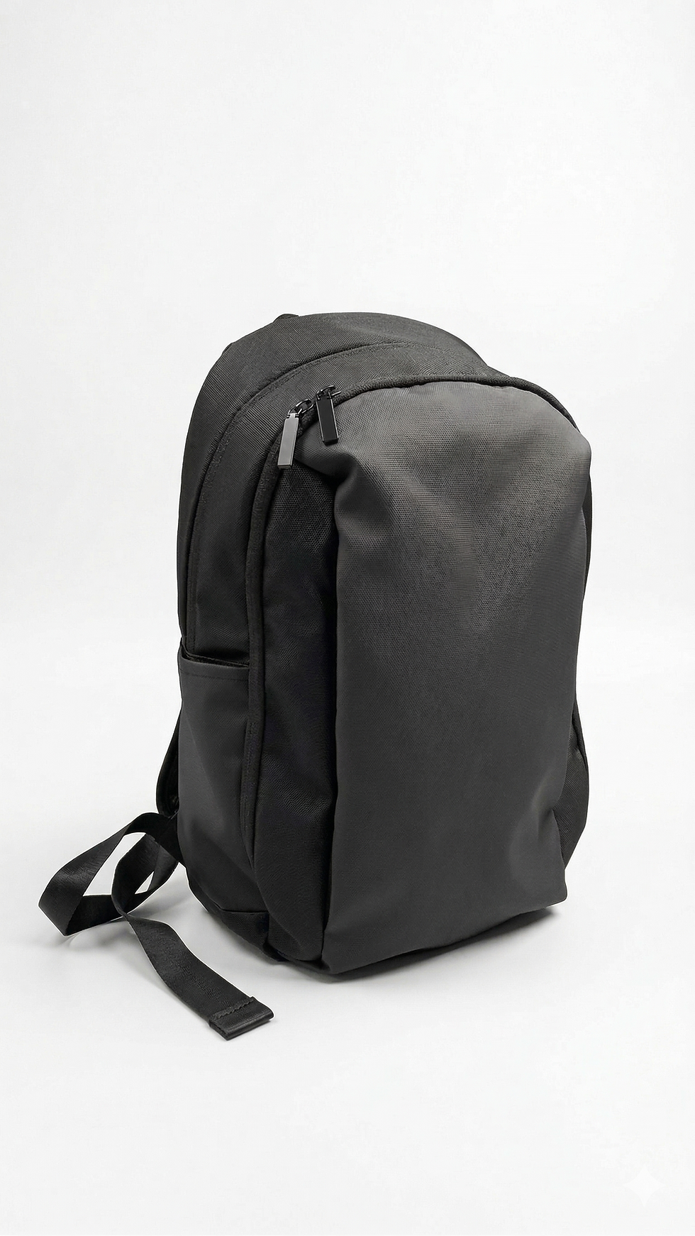 Black minimalist tech backpack with a smooth matte nylon finish and streamlined aerodynamic design.