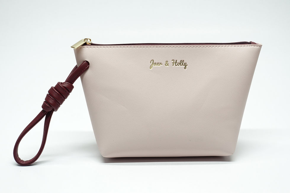 Nude-pink-tapered-vegan-leather-pouch-with-knotted-burgundy-wristlet-strap-gold-logo-factory.
