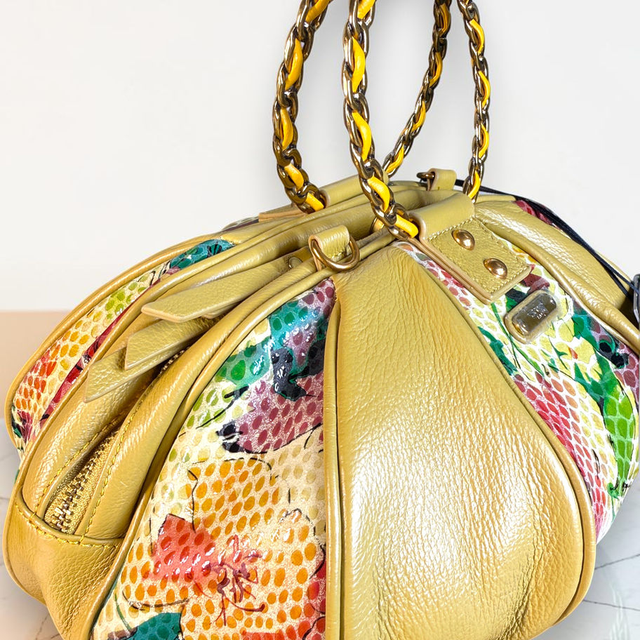 Side view of Sharif Sunshine floral leather balloon bag with sculpted panels