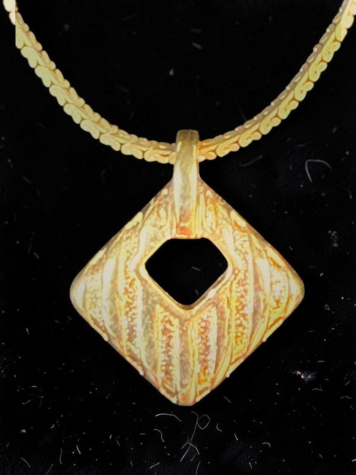Christian Dior vintage geometric pendant close-up showing raised textured detailing